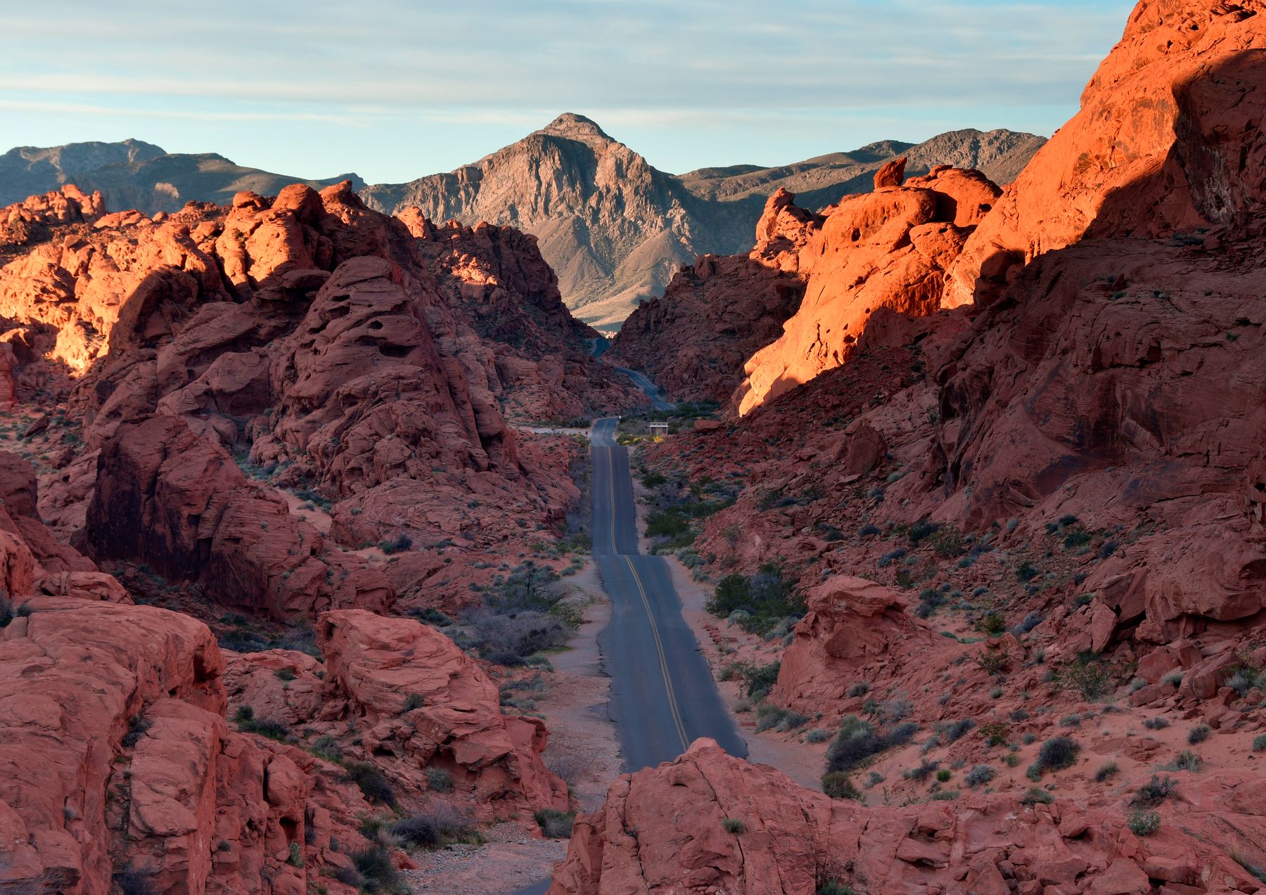 Highway crossing red sandstone desert terrain near Las Vegas, Nevada