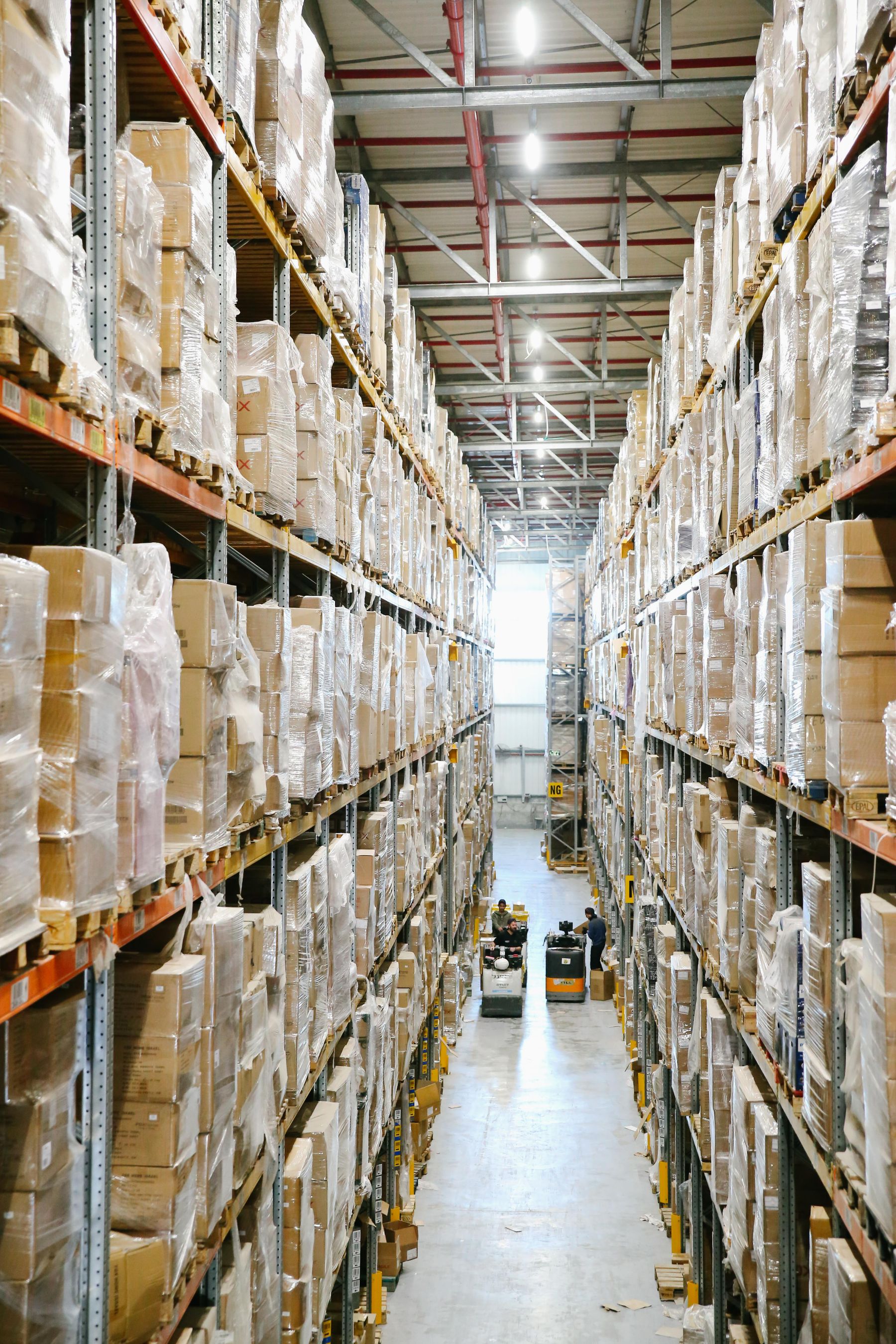 Organized warehouse aisles lined with shelves and boxed inventory